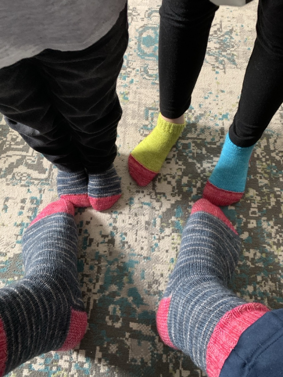 A triptych: Three pairs of coordinating socks knit in 2020 for my brother-in-law, my niece, and my nephew.