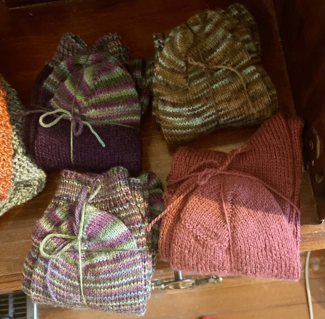 An array of four pairs of socks, knitted as Christmas gifts for my mom, sister, and sisters-in-law.